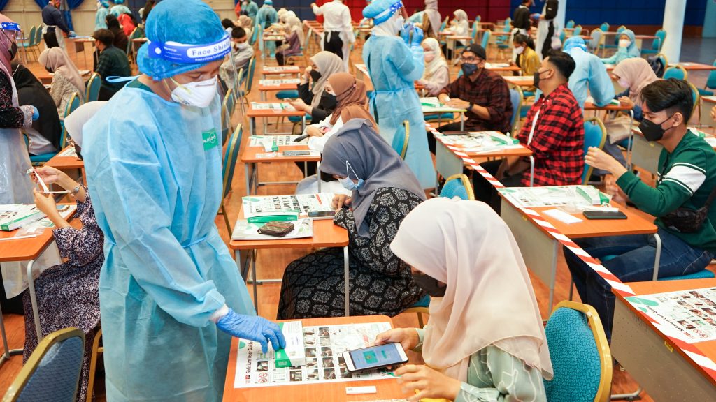 Clinical staff monitoring Salixium procedure on one of the student.